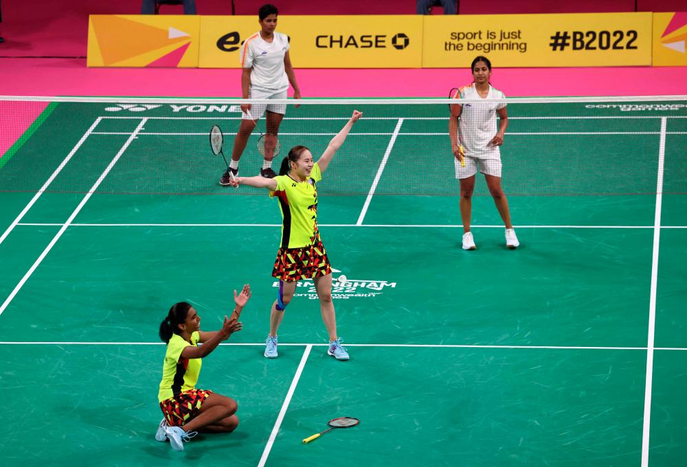 Malaysia's Koong Le Pearly Tan and Muralitharan Thinaah (L) celebrate victory over India's Gayatri Gopichand Pullela and Treesa Jolly to clinch gold in the Mixed Team Gold Medal badminton match between Malaysia and India on day five of the Commonwealth Games at the NEC Arena in Birmingham, central England, on August 2, 2022. AFPPIX