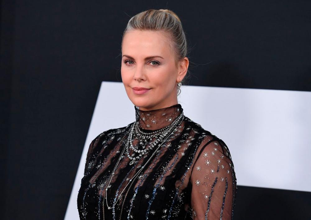 Charlize Theron reprising her role as Morticia Addams