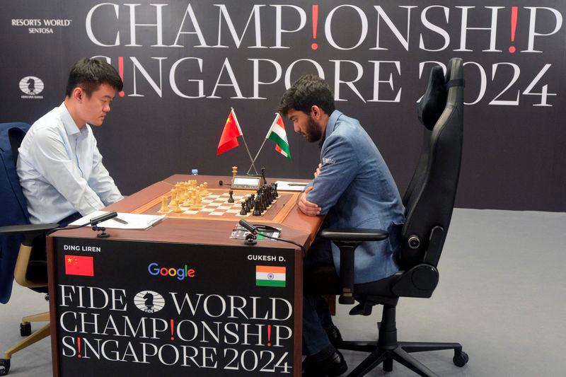 China's chess grandmaster Ding Liren (L) and India's grandmaster Gukesh Dommaraju (R) compete in the final game of the 2024 FIDE World Championship in Singapore on December 12, 2024. - AFPPIX