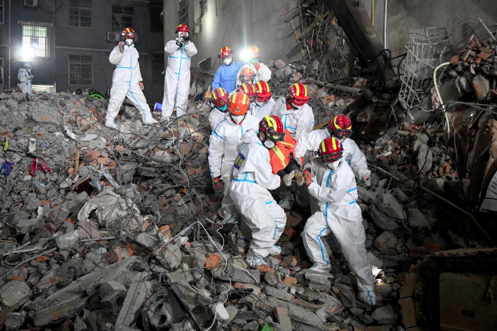 Rescue workers carry a survivor on a stretcher more than 131 hours after a building collapsed in Changsha, Hunan province, China, early May 5, 2022. cnsphoto via REUTERSpix