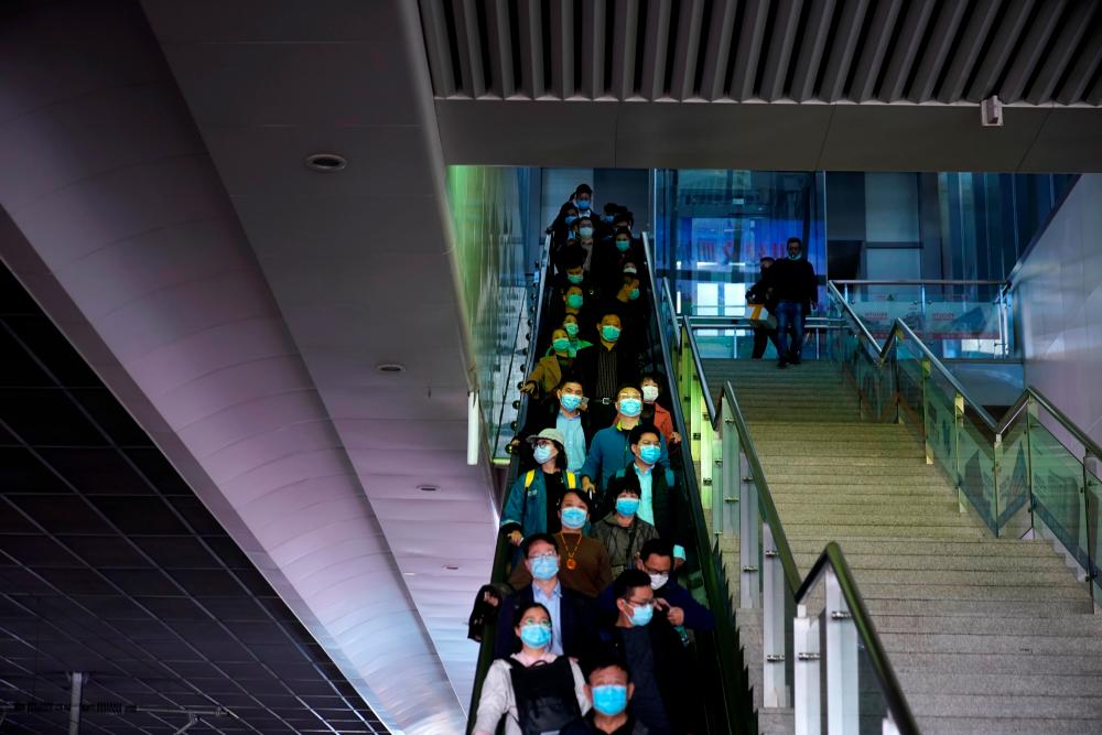 People wearing face masks amid the global outbreak of the coronavirus disease (Covid-19) are seen at Shanghai Hongqiao Railway Station in Shanghai, China October 26, 2020. — Reuters