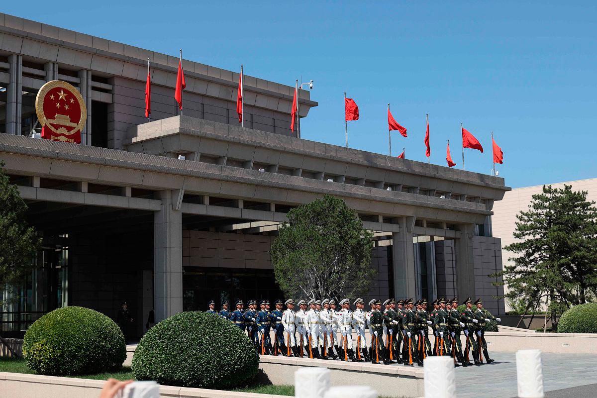 Members of a Chinese honour guard march to the tarmac as they prepare to welcome Zimbabwe’s President Emmerson Mnangagwa at Beijing Capital International Airport in Beijing on September 1, 2025, ahead of a military parade in the capital on September 3 to mark 80 years since the end of World War II. - Lintao Zhang / POOL / AFP