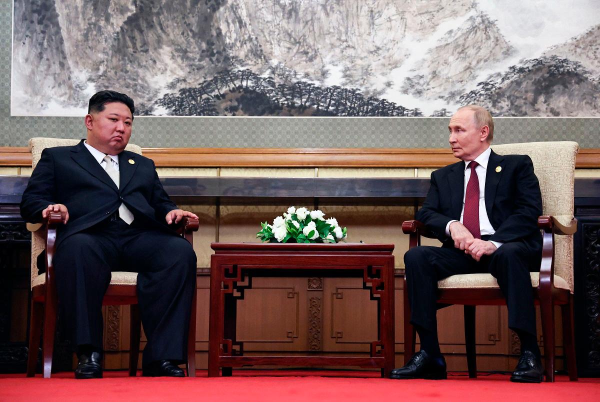 In this pool photograph distributed by the Russian state agency Sputnik, Russian President Vladimir Putin and North Korean State Chairman Kim Jong Un (L) meet after attending a military parade marking the 80th anniversary of victory over Japan and the end of World War II, in Beijing’s Tiananmen Square on September 3, 2025. - Alexander Kazakov / POOL / AFP