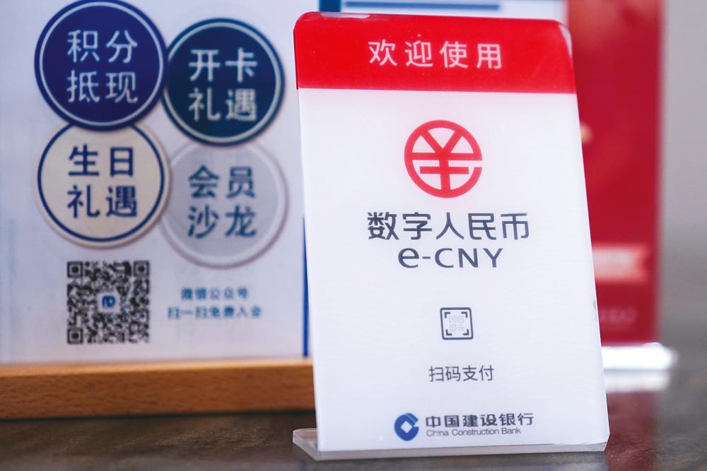 A sign indicating that digital yuan, also referred to as e-CNY, is accepted is pictured at a shopping mall in Shanghai. – REUTERSPIX