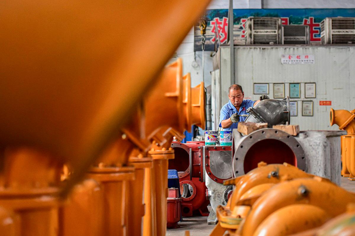 An employee works on a water pump production line at a factory in Qingzhou, in eastern China’s Shandong province on June 30, 2025. - AFPpix