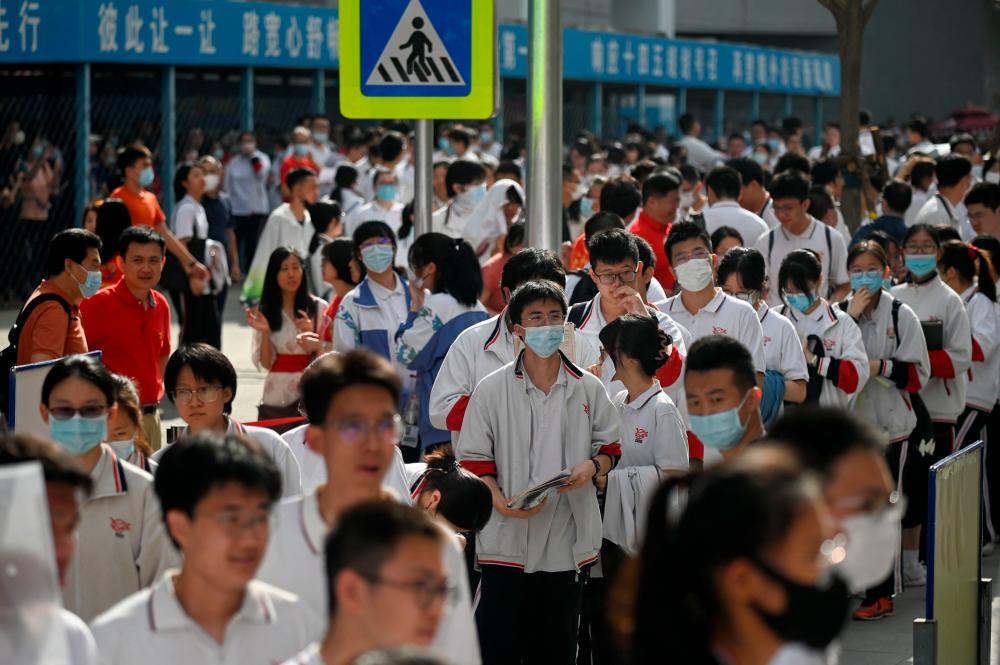 Students line up to enter a school on the first day of China’s national college entrance examination, known as the gaokao, in Beijing on June 7, 2023. AFPPIX