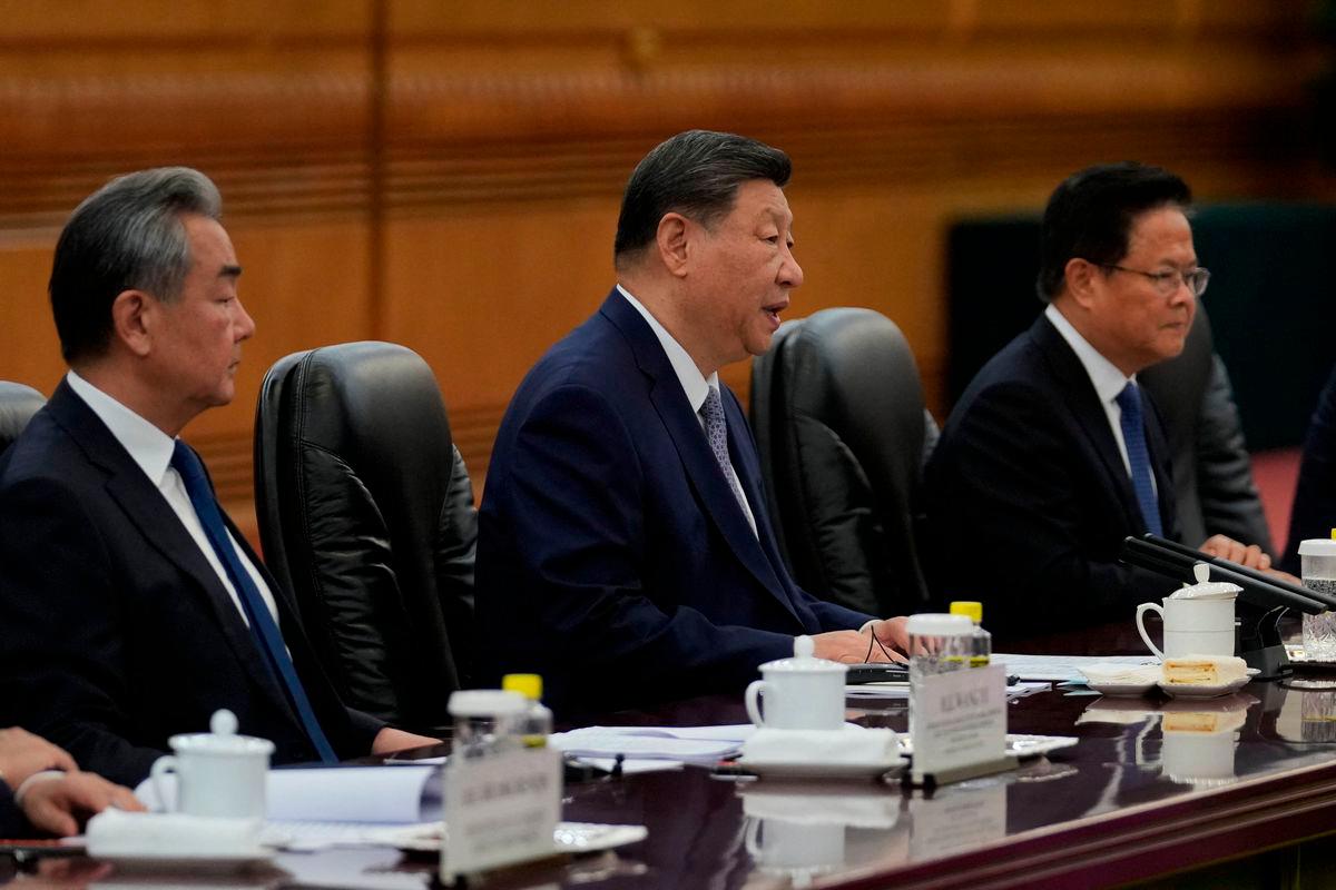 Chinese President Xi Jinping (C) speaks as Foreign Minister Wang Yi (L) looks on during the opening remarks of the EU-China summit at the Great Hall of the People in Beijing -