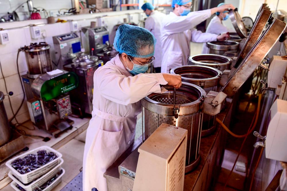 This photo taken on Feb 20, 2020 shows a medical worker boiling traditional Chinese medicine at a hospital in Shenyang in China's northeastern Liaoning province. — AFP