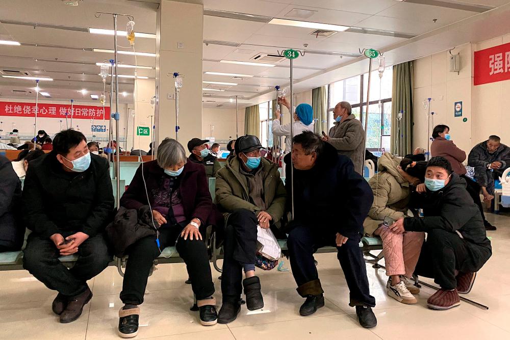Patients with Covid-19 coronavirus rest in a hallway at Fengyang People's Hospital in Fengyang County in east China's Anhui Province on January 5, 2023. AFPPIX