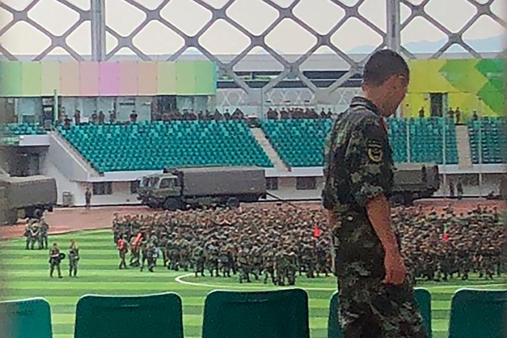 Chinese military personnel gather at the Shenzhen Bay stadium in Shenzhen, bordering Hong Kong in China’s southern Guangdong province, on August 15, 2019. — AFP