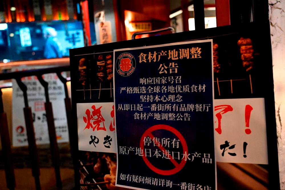 Filepix: This picture shows a sign reading “Suspend the sale of all fish products imported from Japan” an area of Japanese restaurants in Beijing on August 27, 2023/AFPPix