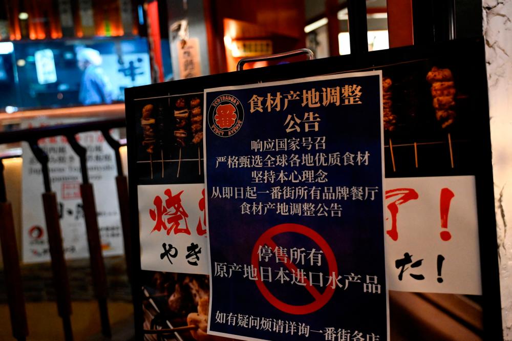 This picture shows a sign reading “Suspend the sale of all fish products imported from Japan” an area of Japanese restaurants in Beijing on August 27, 2023/AFPPix