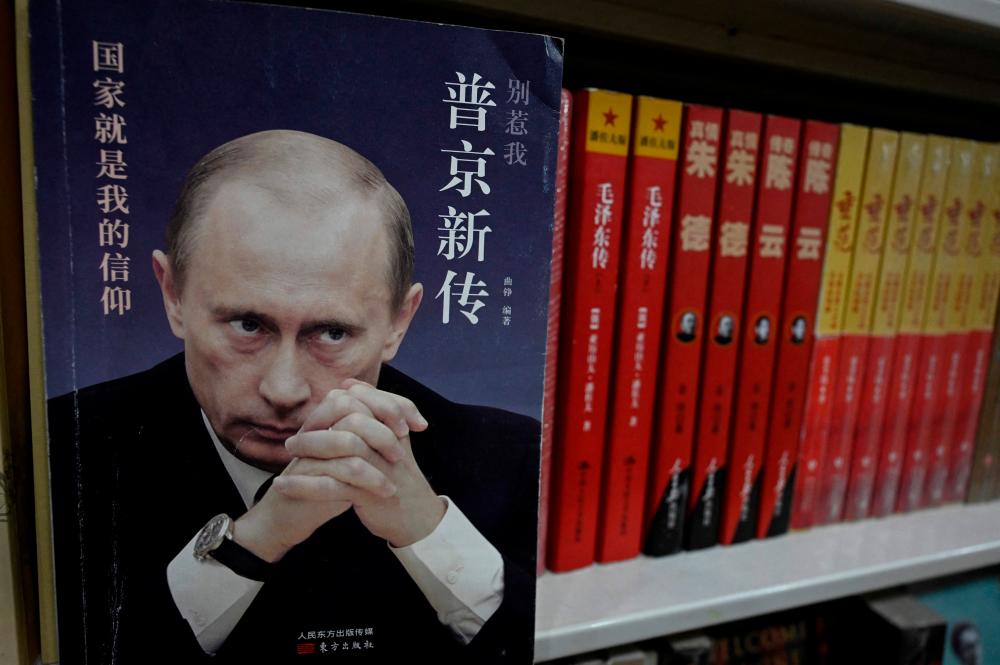 A book about Russian President Vladimir Putin is seen on a bookshelf, at a book store in Beijing on March 20, 2023. AFPPIX