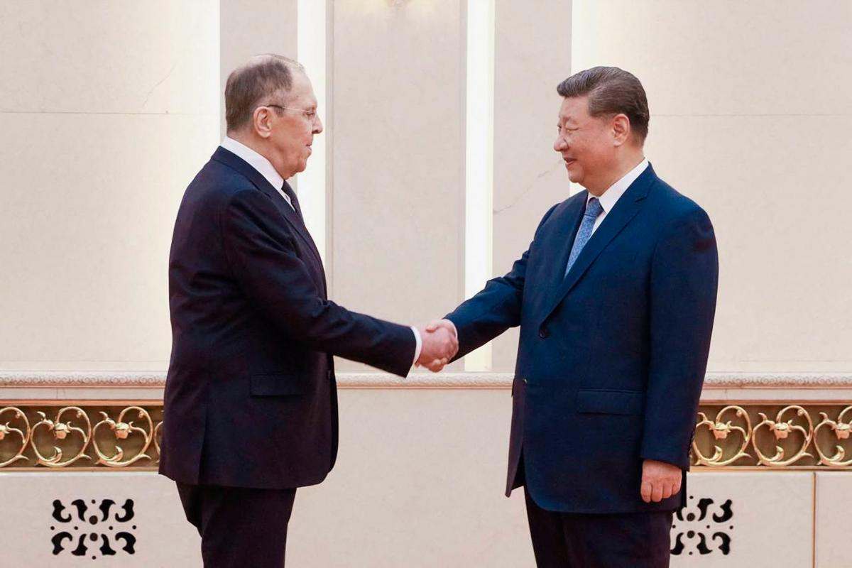 This handout photograph released by the Russian Foreign Ministry shows China’s President Xi Jinping (R) shaking hands with Russian Foreign Minister Sergey Lavrov in Beijing on July 15, 2025. - AFP PHOTO / HANDOUT / RUSSIAN FOREIGN MINISTRY