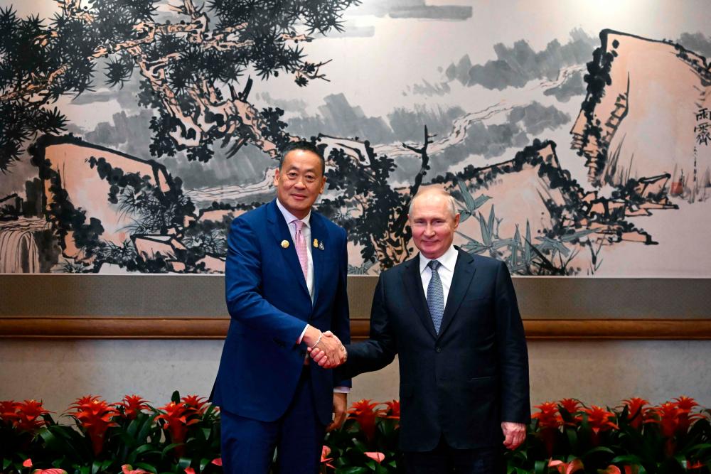 This pool photograph distributed by Russian state owned agency Sputnik shows Russia’s President Vladimir Putin meeting with Thailand’s Prime Minister Srettha Thavisin on the sidelines of the Third Belt and Road Forum in Beijing on October 17, 2023. AFPPIX