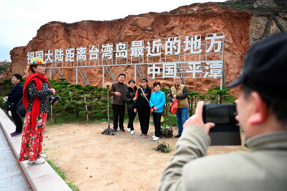 Chinese seaside tourists brush off military drills over Taiwan