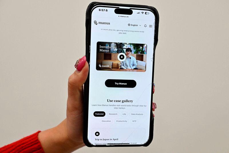 A photo illustration taken in Beijing on March 11, 2025 shows a mobile phone displaying an introduction screen for the AI assistant tool Manus, released by Chinese startup Butterfly Effect. AFPpix