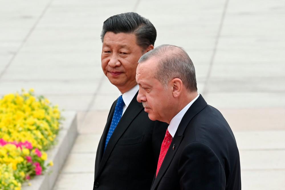 Turkish President Recep Tayyip Erdogan (R) and Chinese President Xi Jinping (L) inspect Chinese honour guards during a welcome ceremony outside the Great Hall of the People in Beijing on July 2, 2019. — AFP