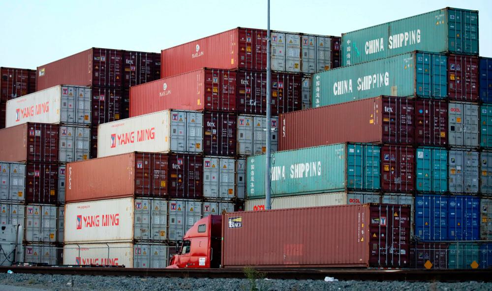 Shipping containers, some marked 'China Shipping', are stacked at the Port of Los Angeles, in San Pedro, California. – AFPPIX