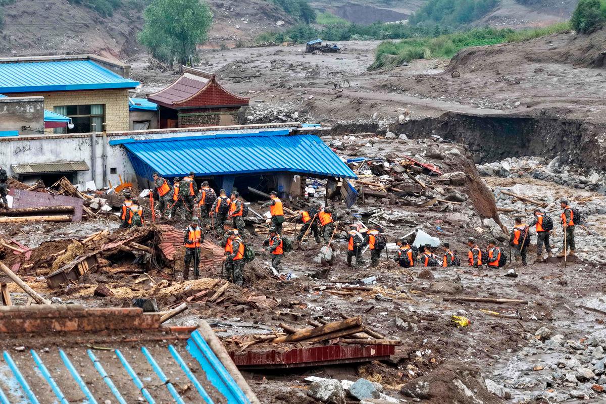 Rescue workers search for survivors after a flash flood in Yuzhong county, in China’s northwest Gansu province on August 8, 2025 - AFP