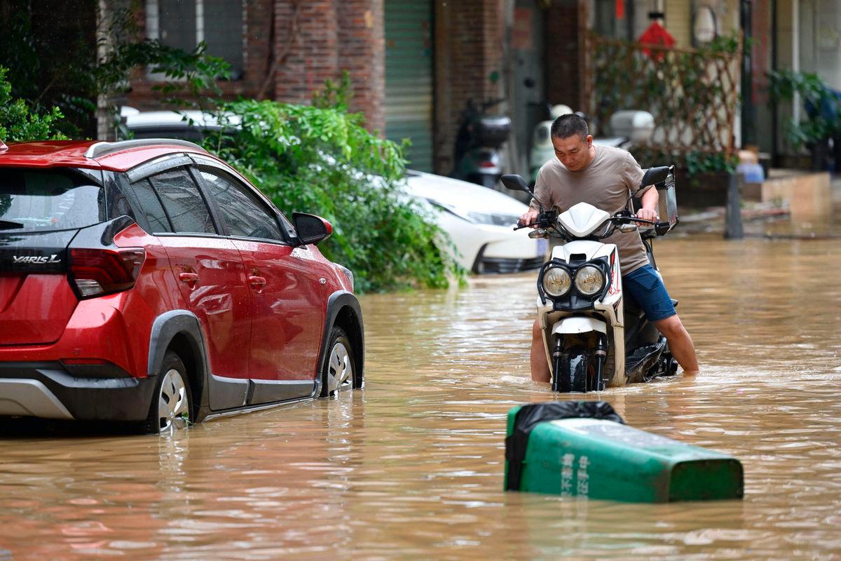 A man rides through a flooded street in Zhongshan, in China’s southern Guangdong province on June 17, 2025. China OUT (Photo by AFP)