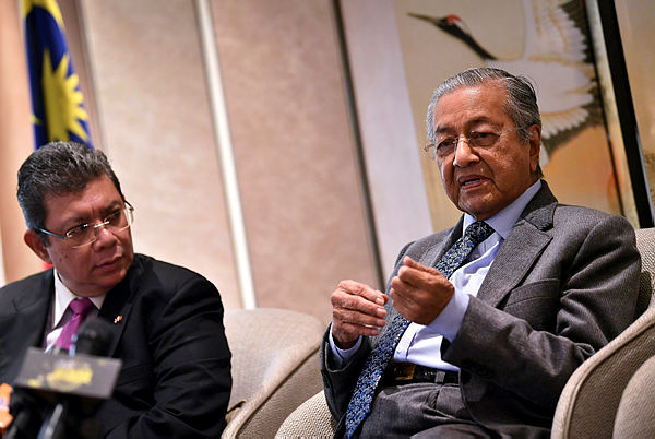 Prime Minister Tun Dr Mahathir Mohamad speaks to a Malaysian media conference at the end of his five-day visit to China on April 28, 2019. He is accompanied by Foreign Minister Datuk Saifuddin Abdullah. — Bernama