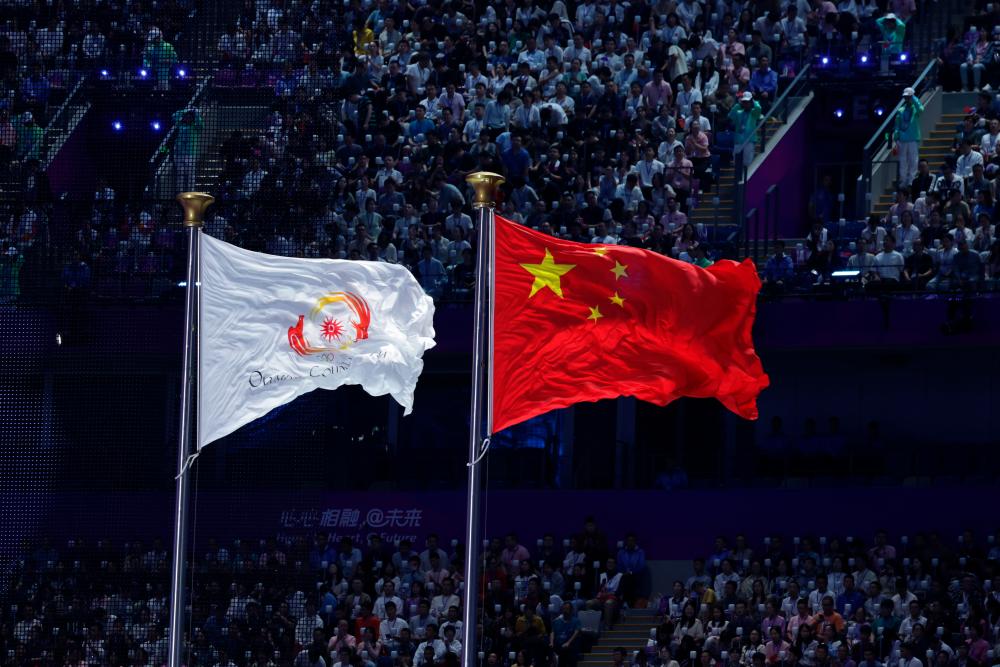 The flag of China and the Olympic Council of Asia flew at the official opening ceremony of the Hangzhou 2022 Asian Games at the Hangzhou Olympic Games Central Stadium on Sept 23 2023. - fotoBERNAMA