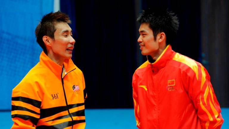 Filepix taken on November 21, 2010 Lin Dan of China (R) talks to Lee Chong Wei of Malaysia as they wait at the podium during an award ceremony after their men’s singles final at the 16th Asian Games in Guangzhou. Fifteen years ago in a packed Kuala Lumpur stadium, rising stars Lin Dan and Lee Chong Wei faced each other in a final for the first time, kicking off badminton’s greatest rivalry and attracting a new generation of fans. - AFP