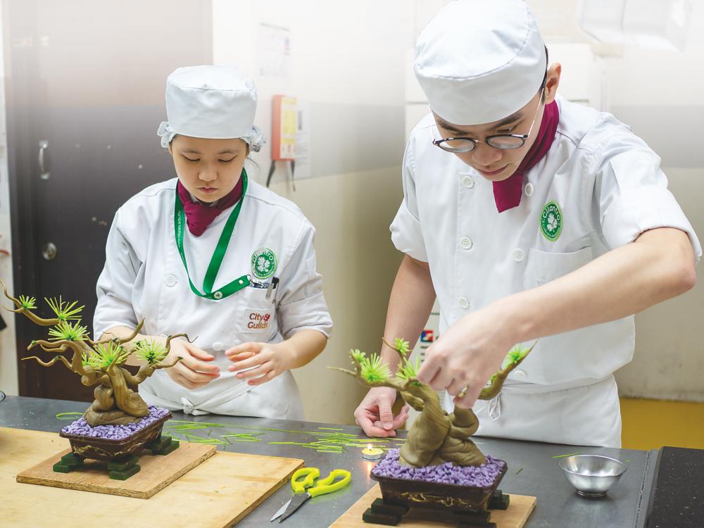 The culinary students in the academy are guided by experienced chef instructors.