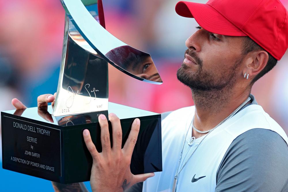 WASHINGTON, DC - AUGUST 07: Nick Kyrgios of Australia celebrates with the Donald Dell Trophy after defeating Yoshihito Nishioka of Japan in their Men's Singles Final match during Day 9 of the Citi Open at Rock Creek Tennis Center on August 7, 2022 in Washington, DC. AFPPIX