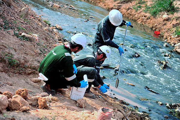 5E Resources Sdn Bhd workers cleaning up the river. — Bernama