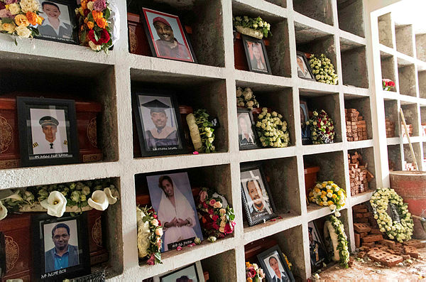 Coffins are arranged inside wall vaults for the Ethiopian Airlines Flight ET 302 plane crash victims, at the cemetery of Balewold Church, part of the Holy Trinity Cathedral Church in Addis Ababa — AFP