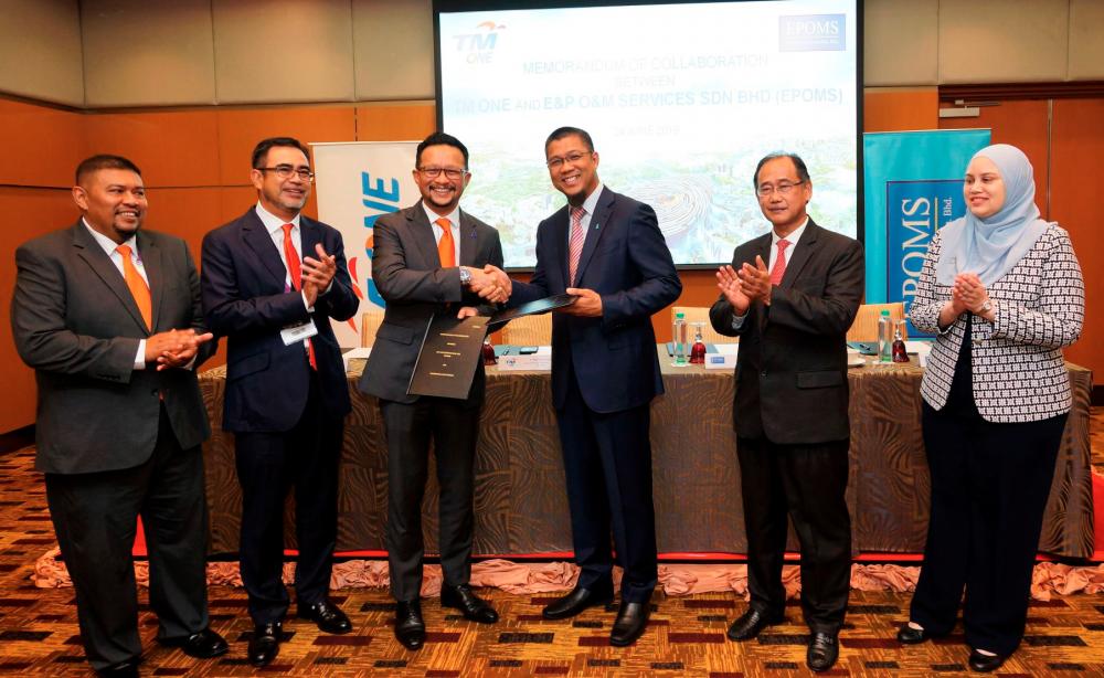 From left: TM ONE director of oil and gas Ahmad Salman Othman, TM ONE CEO Azizi A. Hadi, Imri, Petronas vice president of international assets and EPOMS chairman Mohd Jukris Abdul Wahab, Anuar and Petronas senior legal counsel and EPOMS company secretary Syarifah Isadora Alyahya Syed Mohamed during the signing of the memorandum of collaboration.