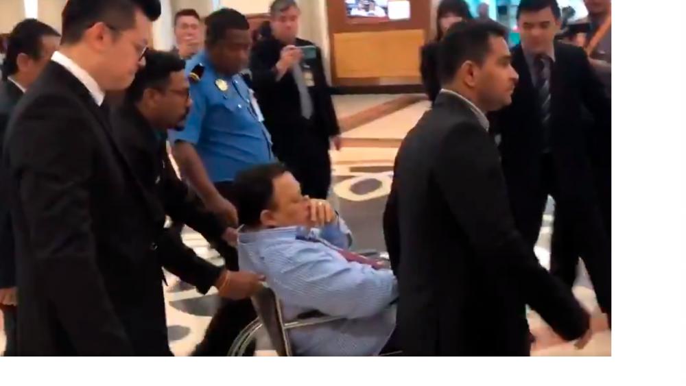 Communications and Multimedia Deputy Minister Eddin Syazlee Shith seen in a wheelchair in the Dewan lobby. - Astro Awani