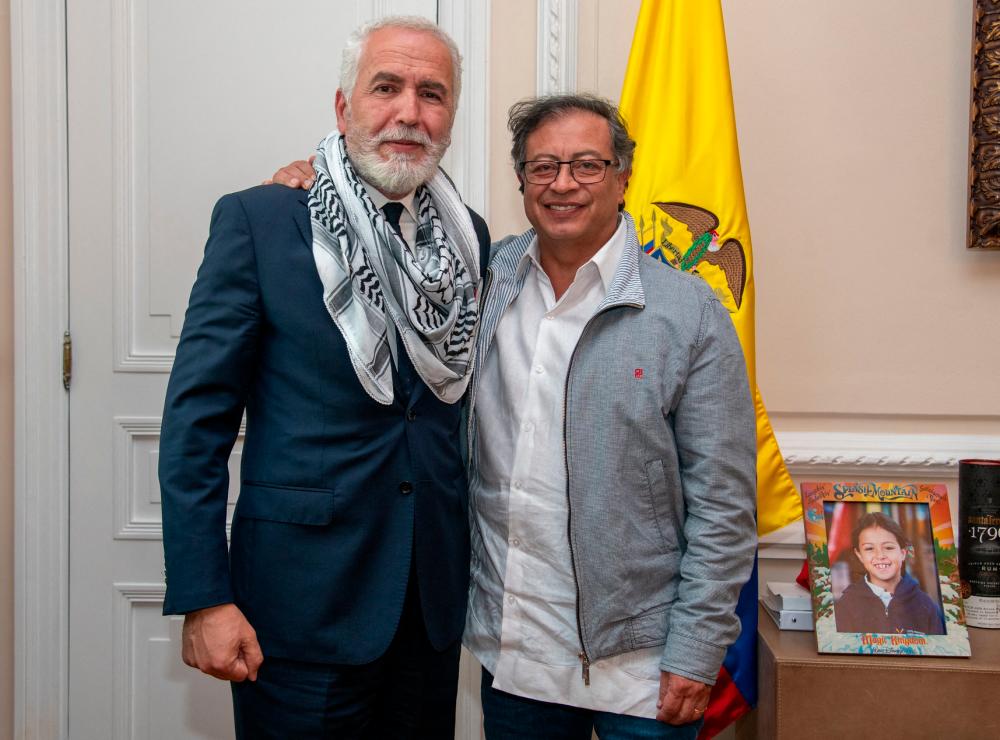 Handout photo released by Colombian Presidency showing President Gustavo Petro (R) posing with Palestine Ambassador to Colombia, Raouf Almalki//AFPix