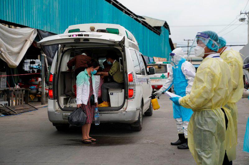 A health worker sprays disinfectant on a patient suspected of contracting coronavirus disease (Covid-19) before being transported in an ambulance into a quarantine center in Phnom Penh, Cambodia, April 21, 2021. — Reuters