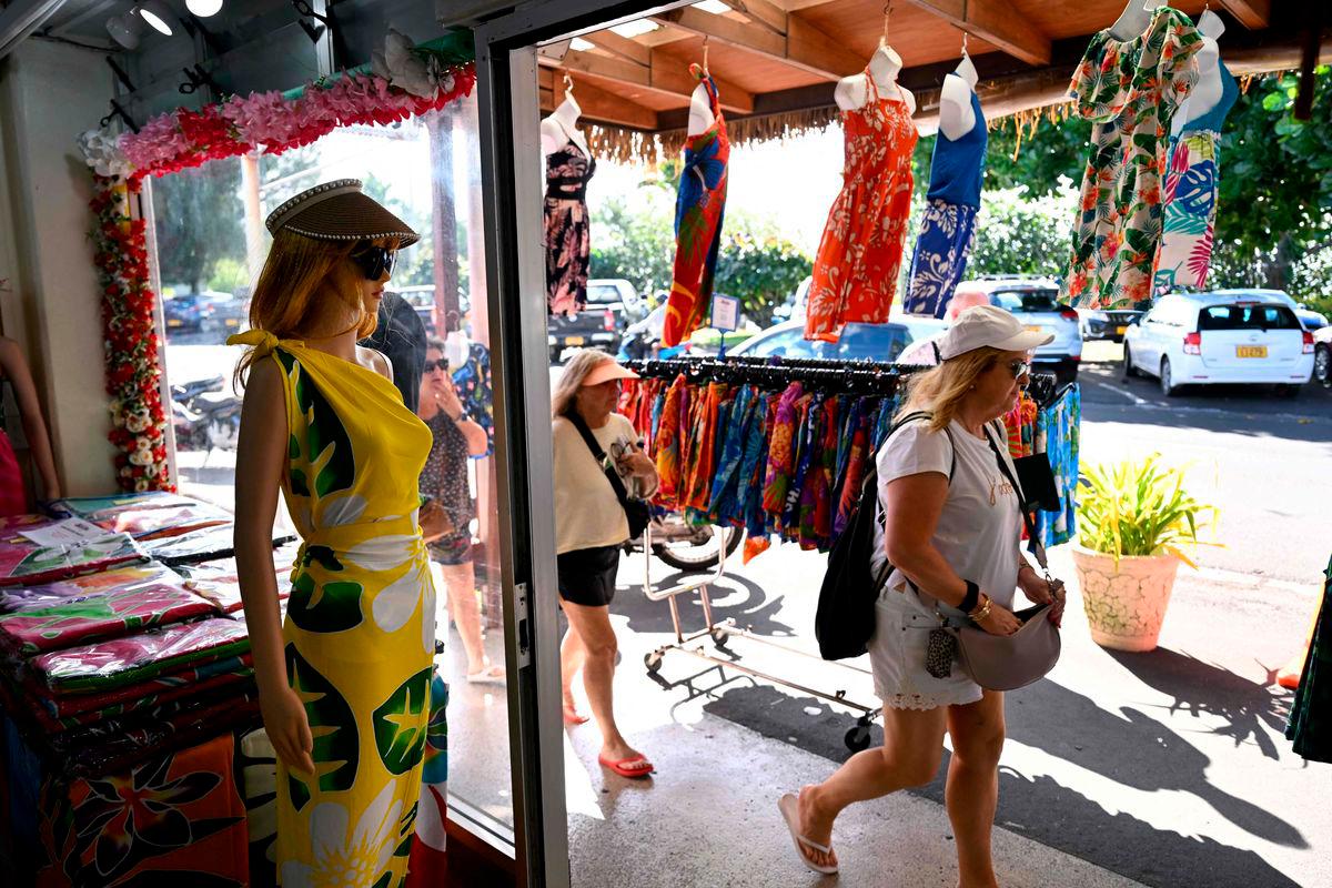 A photo taken on June 11, 2025 shows tourists shopping on the main island of Rarotonga. AFPPIX