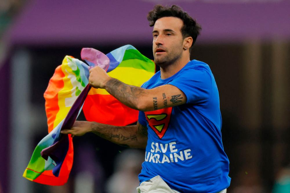 Mario Ferri, 35, who calls himself “The Falcon”, and wearing a t-shirt reading “Save Ukraine” invades the pitch waving a rainbow-coloured Peace flag on the pitch during the Qatar 2022 World Cup Group H football match between Portugal and Uruguay at the Lusail Stadium in Lusail, north of Doha on November 28, 2022. AFPPIX