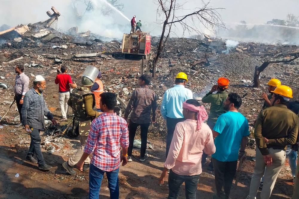 Rescue personnel and local residents gather near a firecracker plant following an explosion at Harda district in India’s Madhya Pradesh state on February 6, 2024/AFPPix