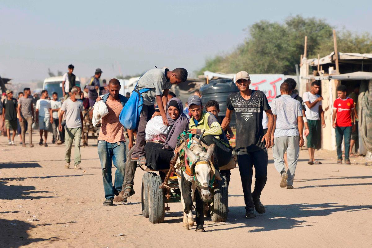 Palestinians make their way in the Mawasi area of Rafah on July 24, 2025, after receiving humanitarian aid from an aid distribution point in the southern Gaza Strip - AFPPix