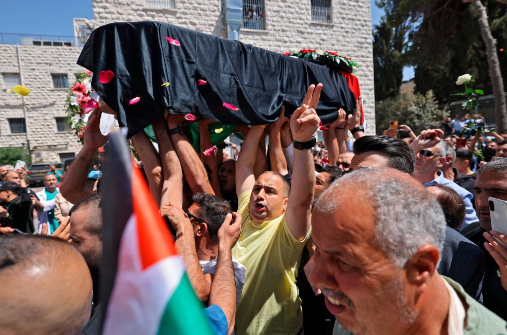 The body of of slain veteran Al-Jazeera journalist Shireen Abu Akleh arrives at a hospital in the east Jerusalem neighbourhood of Sheikh Jarrah/AFP