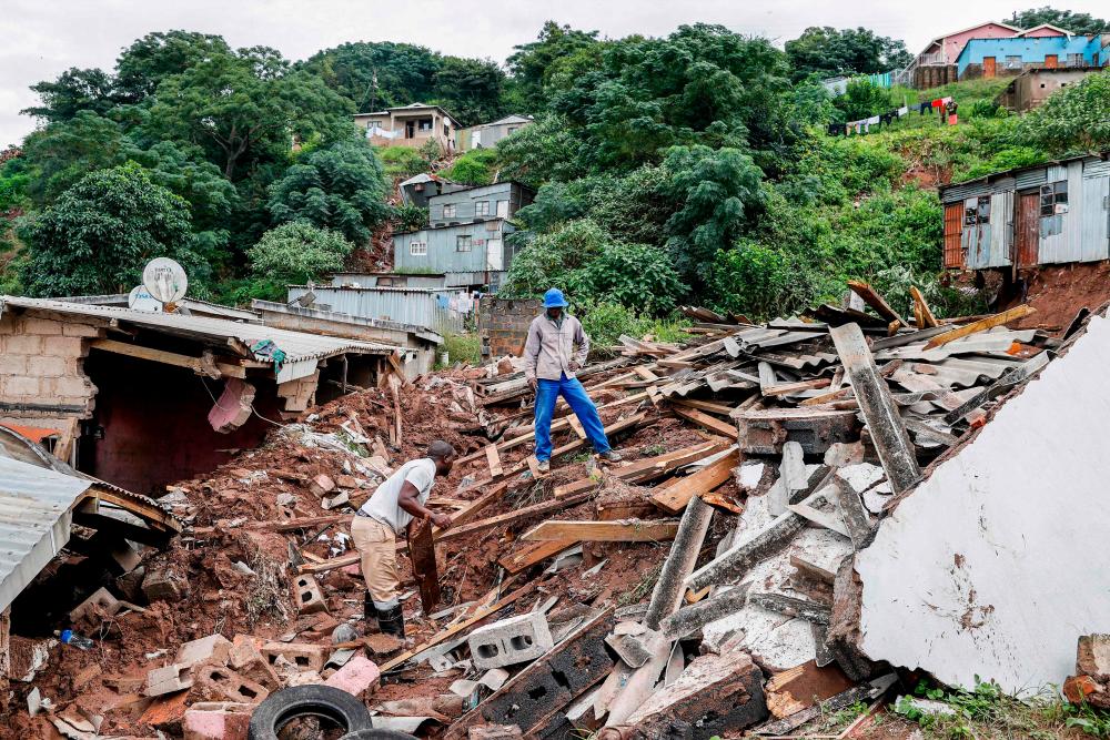 Residents salvage the remains of what use to be the United Methodist Church of South Africa in Clermont, near Durban, on April 13, 2022, following heavy rains that left four children dead in the area. AFPPIX