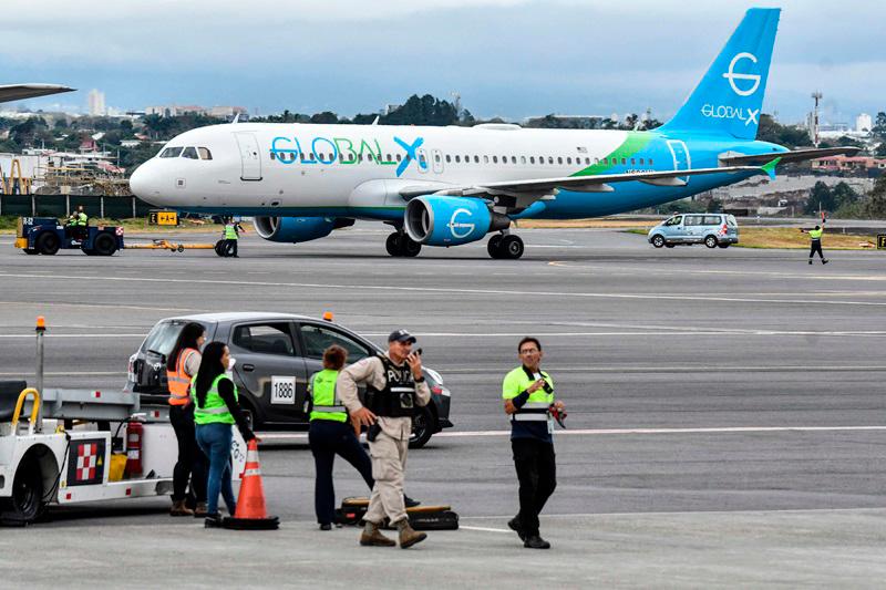 An airplane carrying 135 migrants from the United States is pictured after landing at the Juan Santamaría International Airport in Alajuela, Costa Rica, on February 20, 2025. - Ezequiel BECERRA / AFP