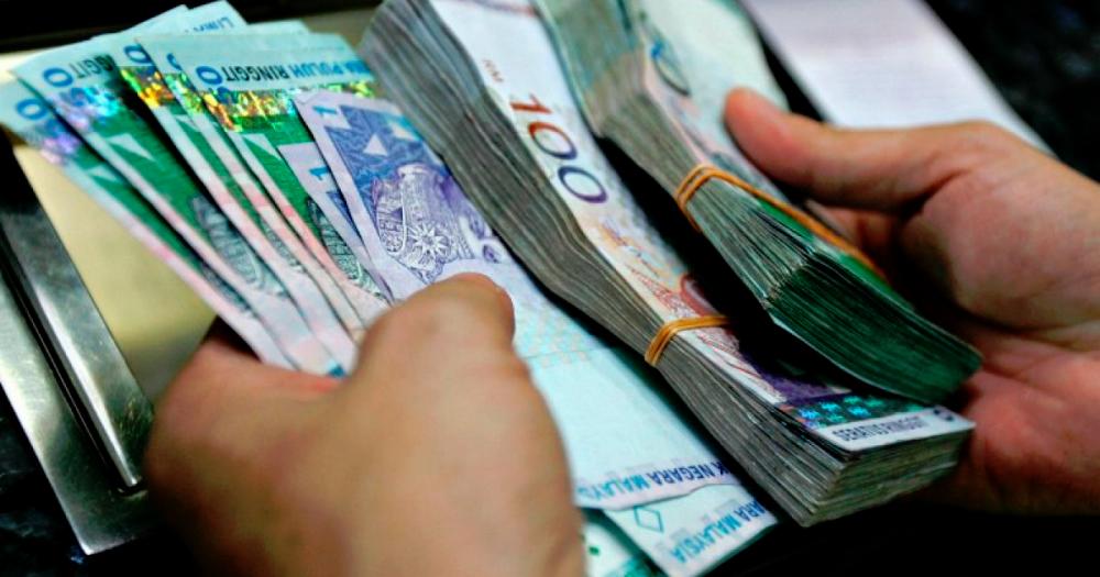AmBank Research says an interest rate cut is also seen as a way to keep the ringgit competitive against the dollar. – AFPPIX