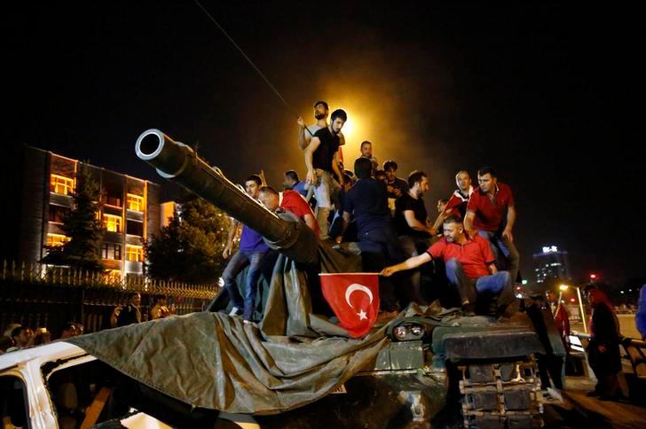 People stand on a Turkish army tank in Ankara, Turkey July 16, 2016. — Reuters