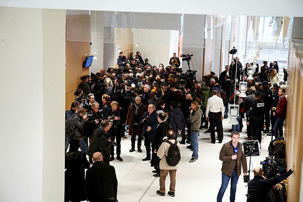 A general view show people arriving, on Feb 13, 2019 at the Paris courthouse, for the opening hearing of the trial of Christophe Dettinger. — AFP