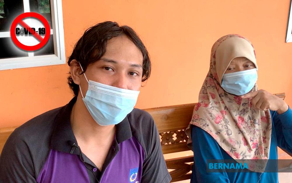Healthcare worker Hisyamuddin Musni (left) and mother feel shunned by their community after recovering from COVID-19. -Bernama