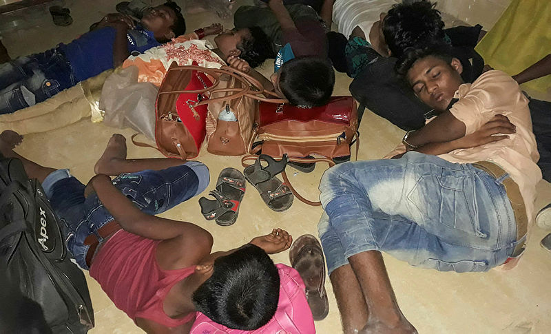 Young Rohingya refugees sleep in a police station before being returned to the camps in Cox’s Bazar on May 15, 2019, after they were rescued from going on a sea voyage to Malaysia. — AFP
