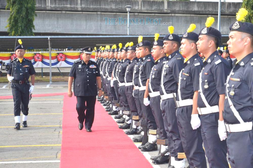 Omar inspecting members of the police force during his working visit to IPD Kota Kinabalu. — Borneo Post