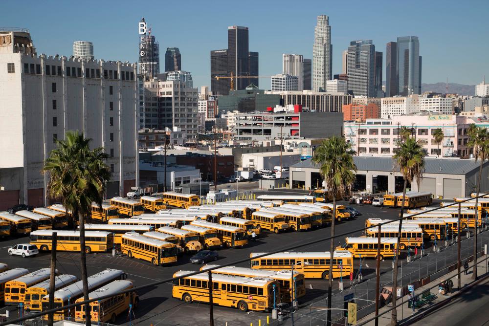 School buses stand idle as all Los Angeles city schools are shut down in reaction to a threat on December 15, 2015 in Los Angeles, California. AFPPIX